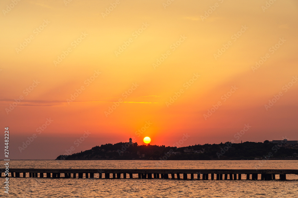 Beautiful sunset above the sea with mountain line on a skyline Beautiful sunset above the sea with mountain line on a skyline