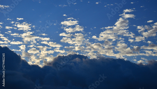 Dawn with low clouds of peculiar shapes and blue sky background 