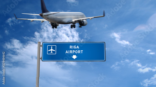 Plane landing in Riga with signboard