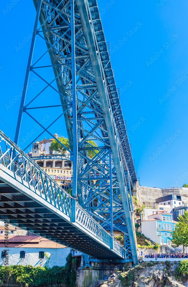 Fototapeta premium Fragment of famous steel bridge dom Luis above connects Old town Porto with Vila Nova de Gaia at river Douro, Portugal.