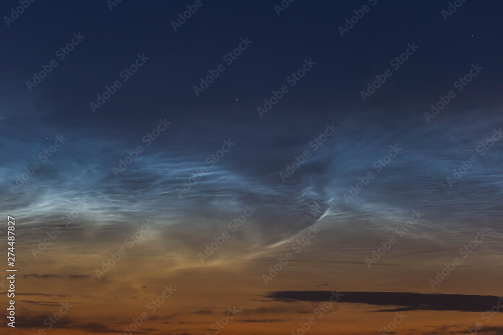 noctilucent clouds at midnight in the sky