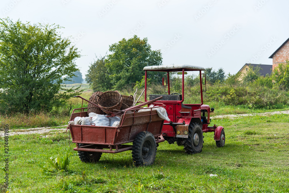 Tractor with full trailer of harvest. Harvesting, autumn Tractor with full trailer of harvest. Harvesting, autumn