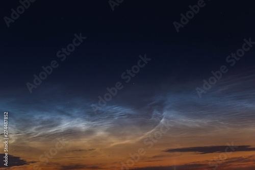 noctilucent clouds at midnight in the sky