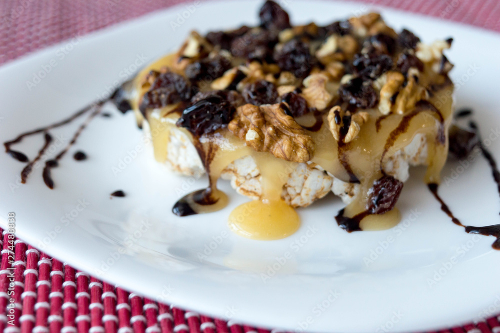 Rice biscuit with honey, nuts and raisins without seeds bathed in light chocolate threads. Rice biscuit with honey, nuts and raisins without seeds bathed in light chocolate threads.