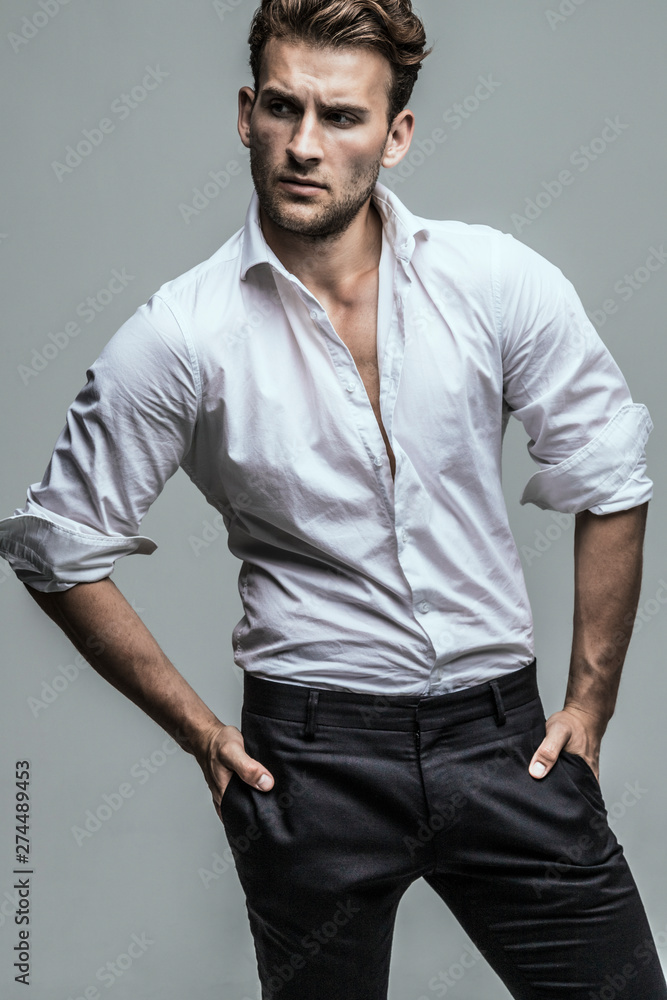 Portrait of young and handsome model in a white shirt. Studio shot. Copy space. Portrait of young and handsome model in a white shirt. Studio shot. Copy space.