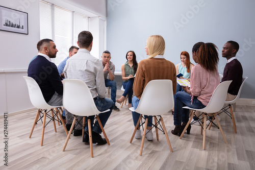 Multi-ethnic People Sitting In Circle Counseling © Andrey Popov