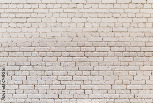 High resolution full frame background of detailed old pale brick wall.