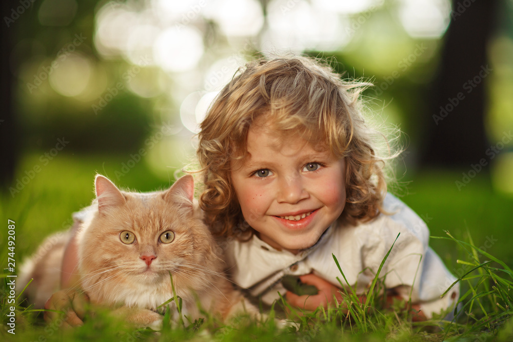 Little curly boy with a redhead cat Little curly boy with a redhead cat