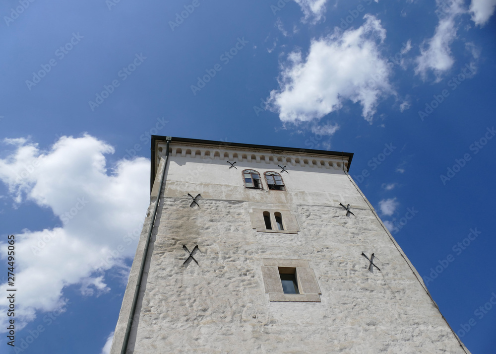 Ancient tower in Zagreb city high in the sky and white clouds 