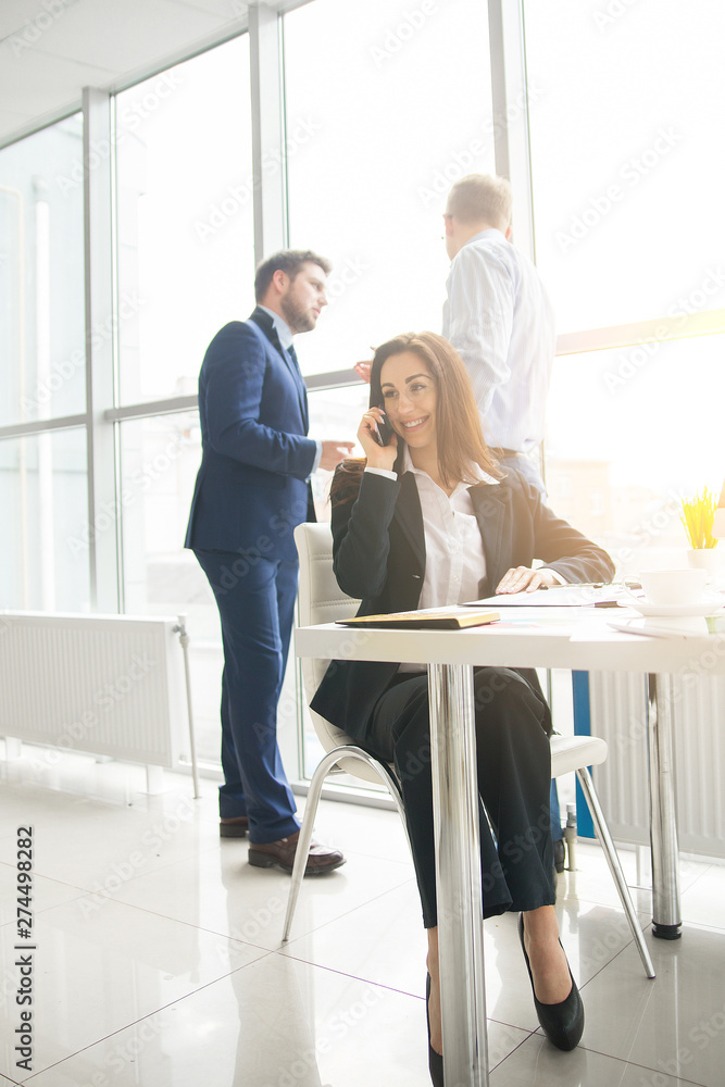 business woman with her staff, people group in background at modern bright office indoors business woman with her staff, people group in background at modern bright office indoors