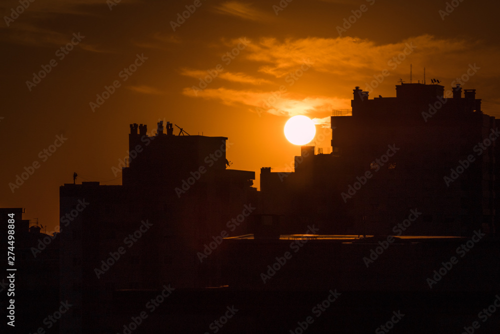 silhouette of city at sunset