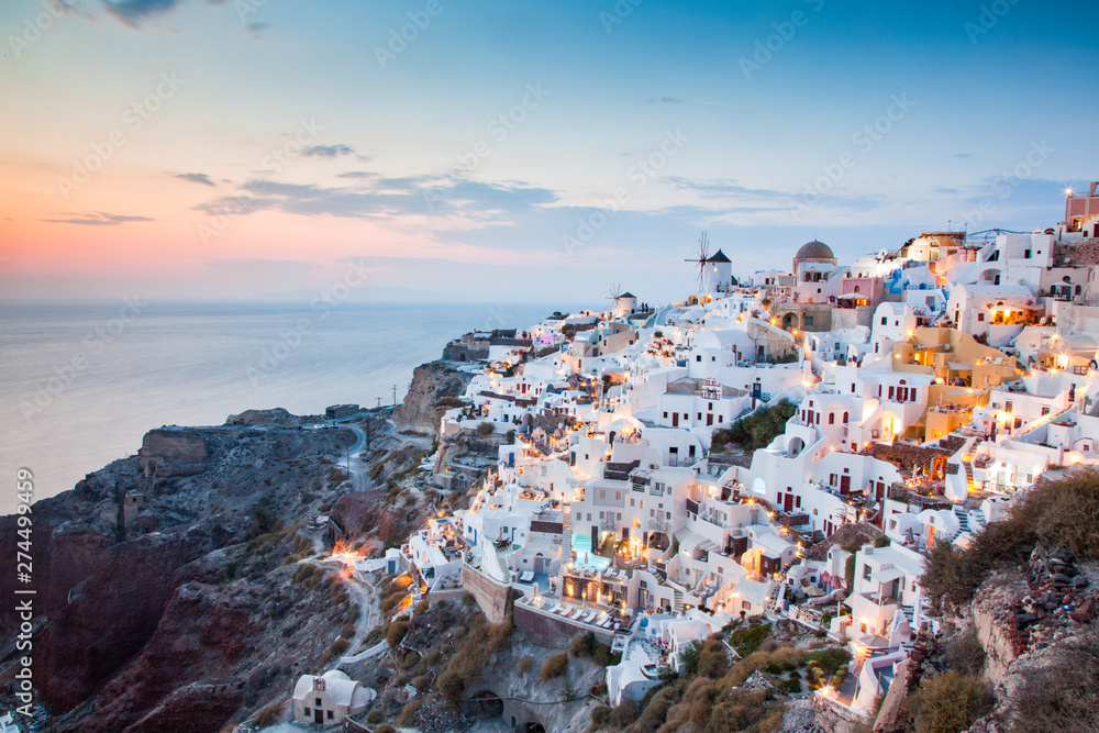 impressive evening view of Santorini island. Picturesque spring sunset on the famous Greek resort Oia, Greece, Europe. Traveling concept background.