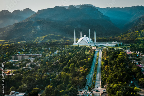 Islamabad / Pakistan - April 25 2019: Aerial photo of Islamabad, the capital city of Pakistan showing the landmark Shah Faisal Mosque and the lush green mountains of the city