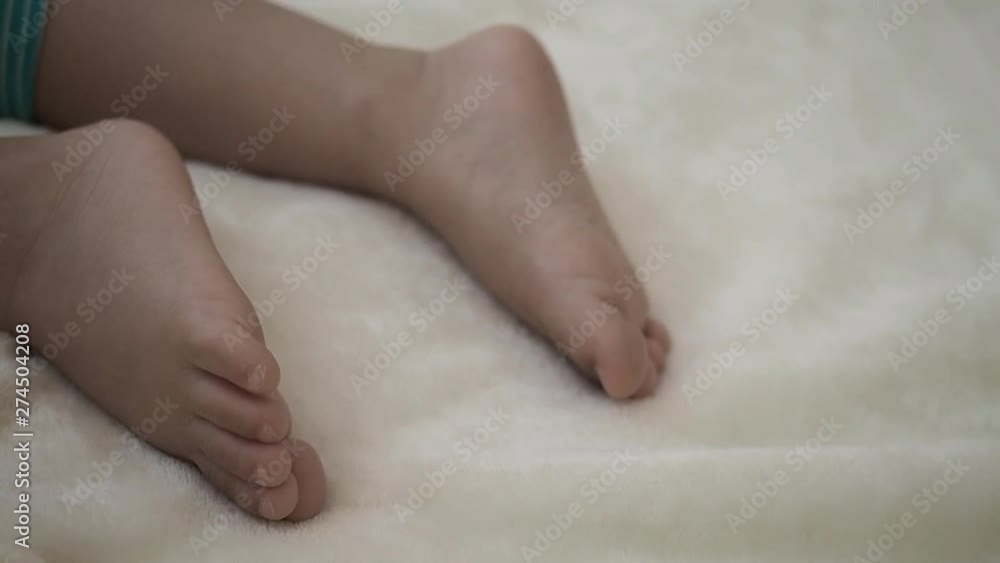 close up foot of sleeping kid moving a little bit. Concept of love family and parenthood relation close up foot of sleeping kid moving a little bit. Concept of love family and parenthood relation
