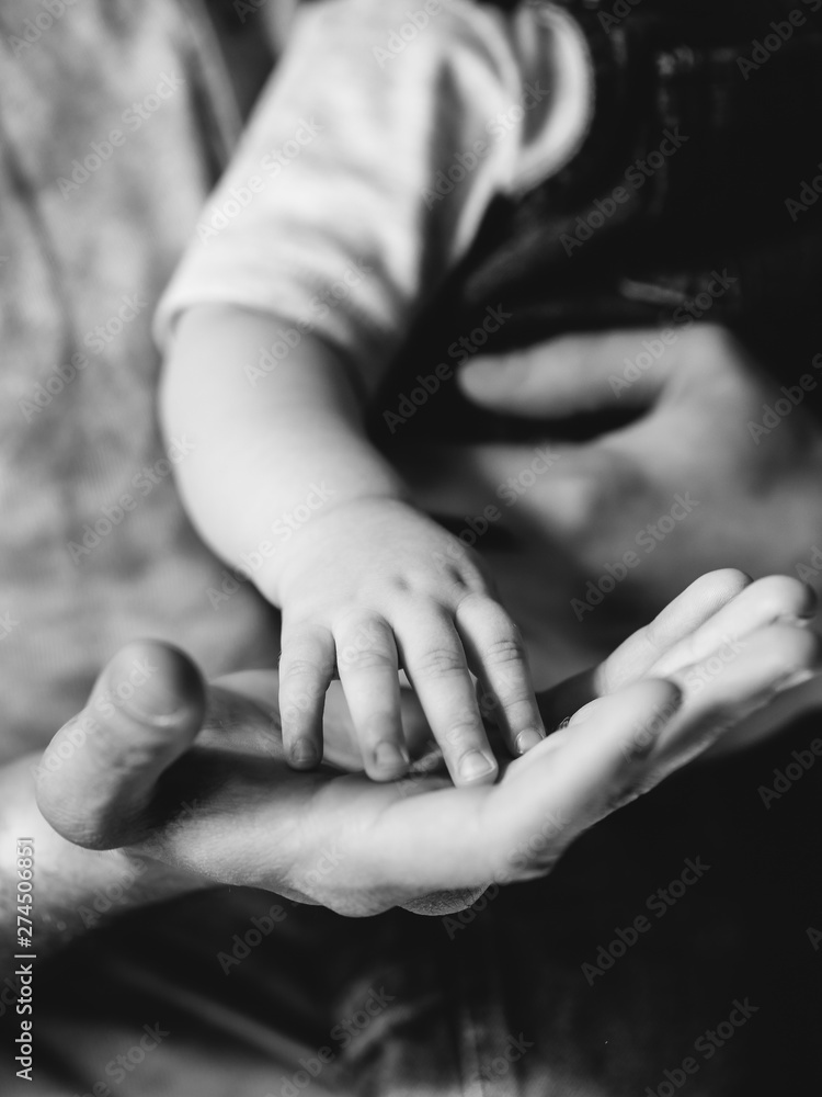 Little palm in the hand of his father. Family and childhood. Son and father. Little palm in the hand of his father. Family and childhood. Son and father.