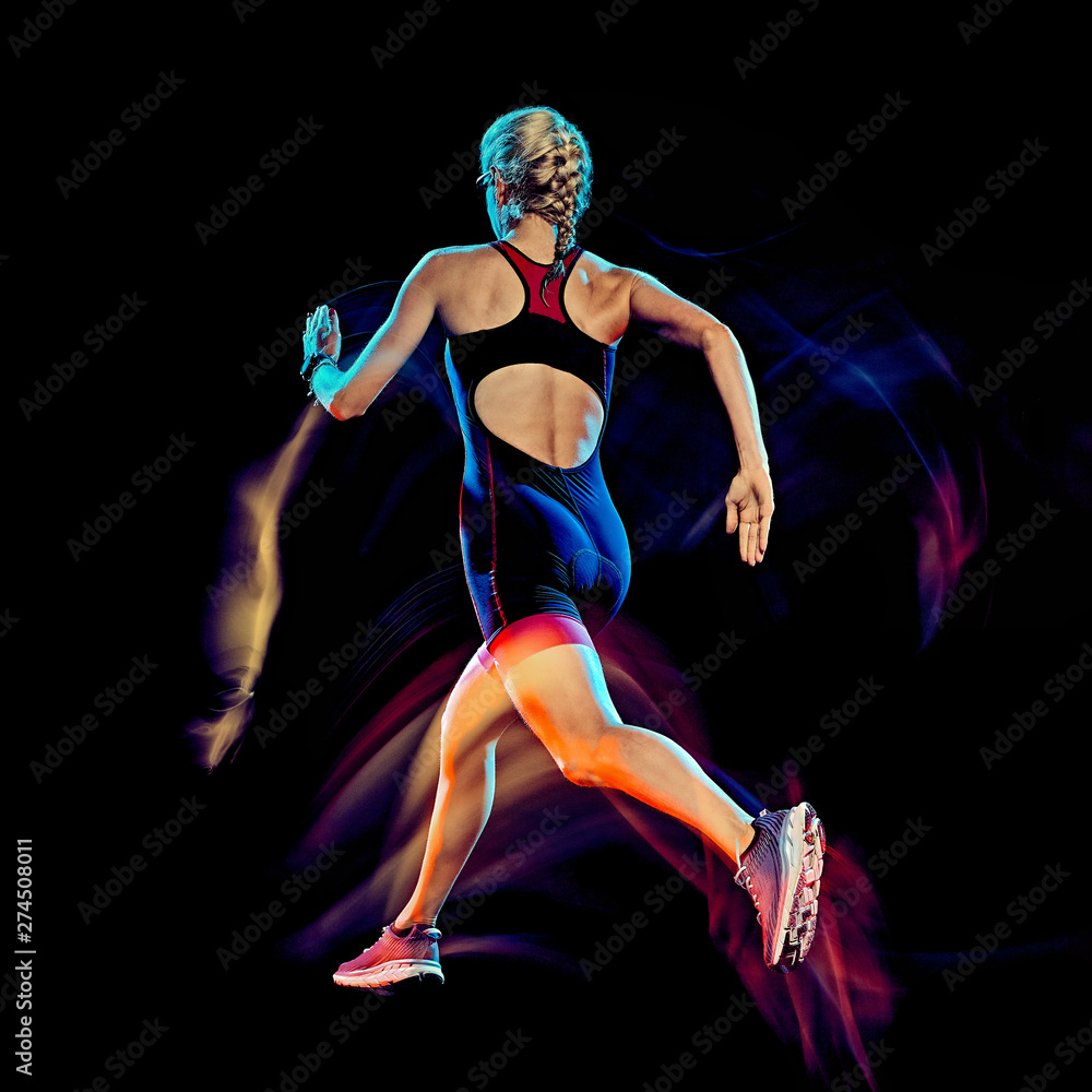 one caucasian woman triathlon triathlete runner running joogger jogging studio shot isolated on black background with light painting effect