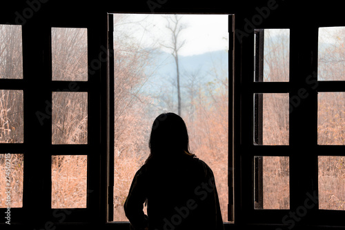 Silhouette woman looking out of window see view mountain in nature.concept thniking a freedom.