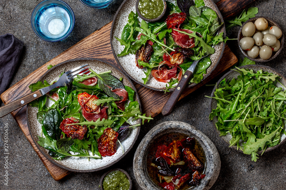 Salad with arugula, spinach, dried tomato and ham serrano paleta iberica. Low carbs keto recipe Salad with arugula, spinach, dried tomato and ham serrano paleta iberica. Low carbs keto recipe