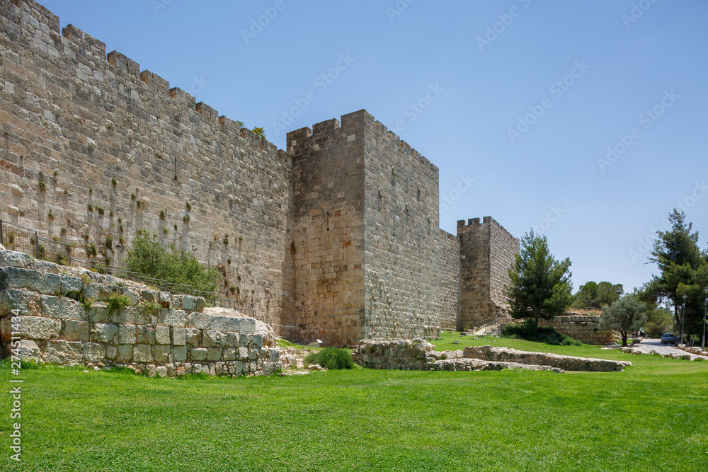 Grass lawn and square tower on wall of old city Jerusalem