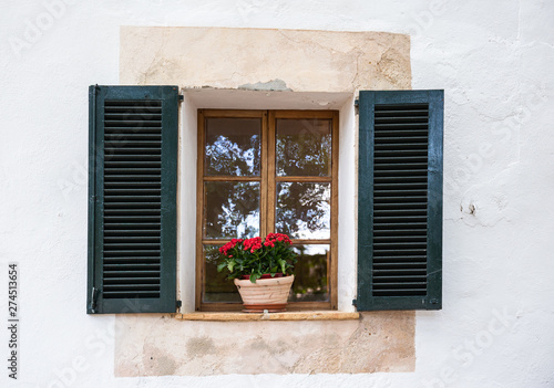 Window in an old house decorated with flower