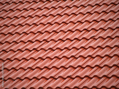Red ceramic roof tiles  close up detail on house roof  seamless  pattern background.