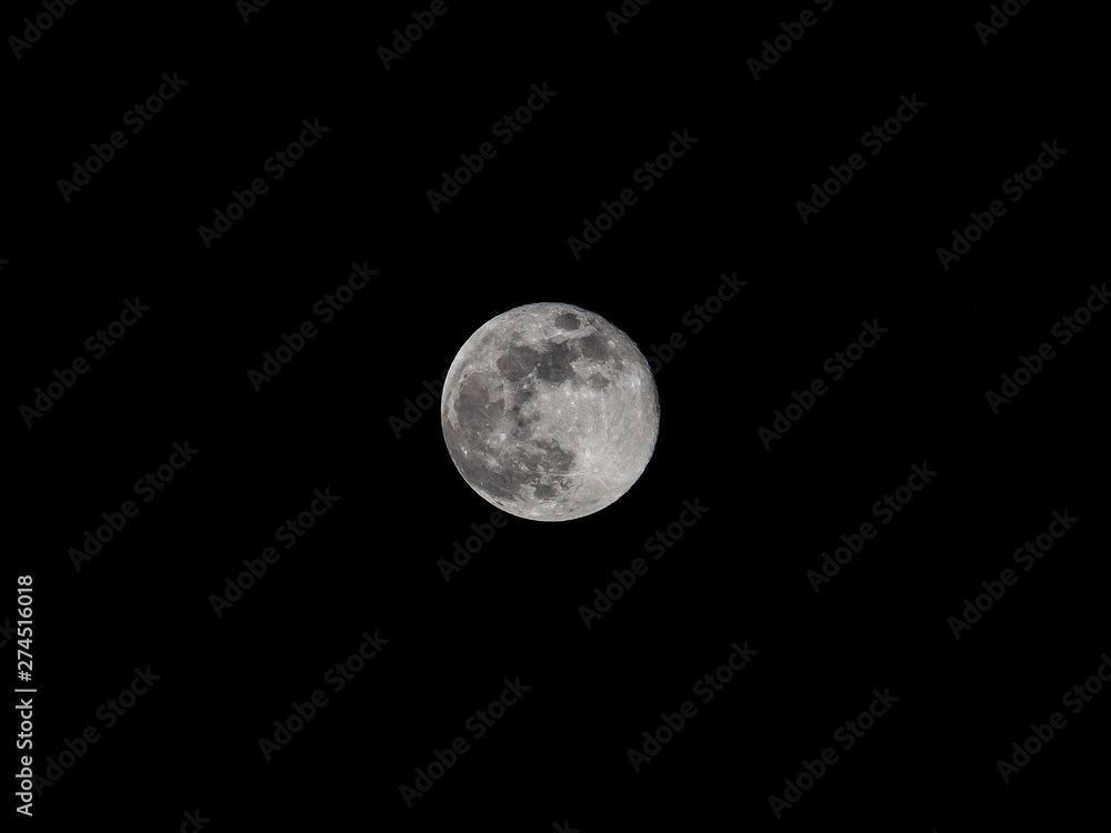 Nearly full moon against black sky Nearly full moon against black sky