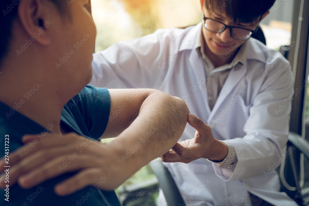 Physical therapists are checking patients elbows at the clinic office room. Physical therapists are checking patients elbows at the clinic office room.