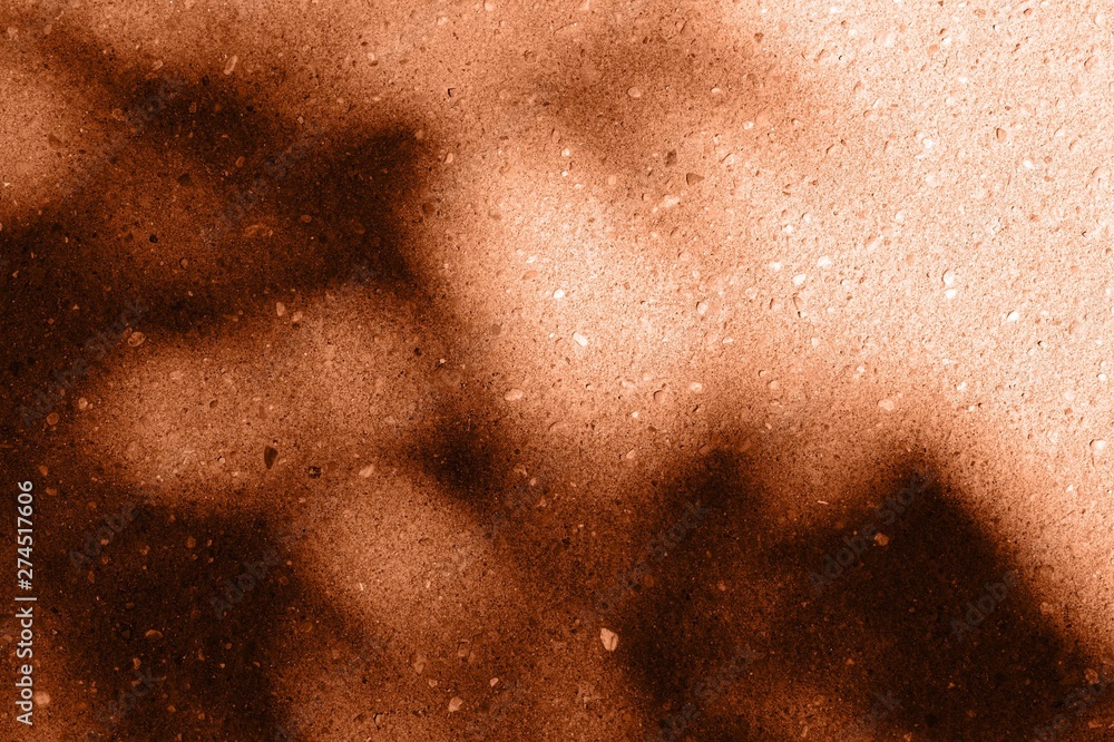 Asphalt surface with the shadow of tree branches close up. Abstract background orange color toned Asphalt surface with the shadow of tree branches close up. Abstract background orange color toned