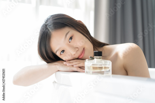Young Asian woman relaxing in a bath . Female skincare concept