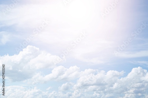Fototapeta Naklejka Na Ścianę i Meble -  Beautiful clear blue sky background with  plain  large white cloud on morning time rays sunlight. space for text. soft focus.