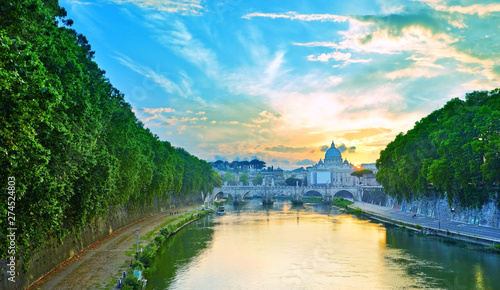 View of St. Peter's Basilica and Aelian Bridge in Rome at dusk.