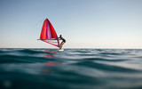 Low angle view of windsurfer sailing on the windsurf board, copy space