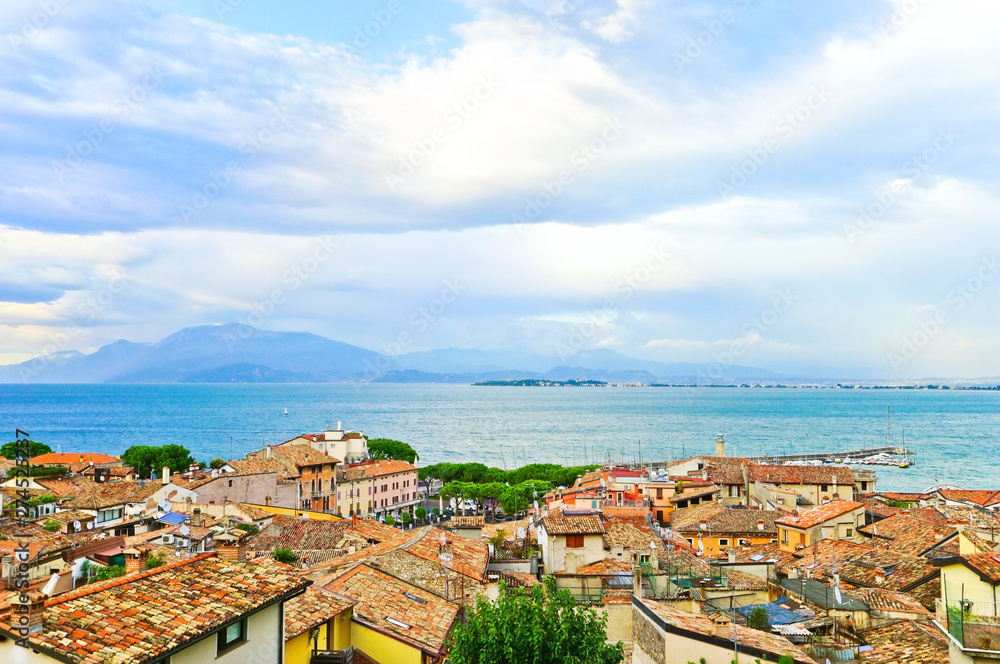 View of Desenzano del Garda at the lakeside of Lake Garda in summer. Desenzano del Garda is a popular holiday location in northern Italy.