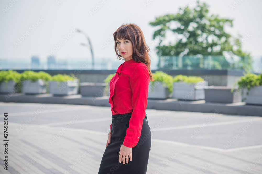 Business woman in city wear red shirt and black skirt, bussinestyle for women 