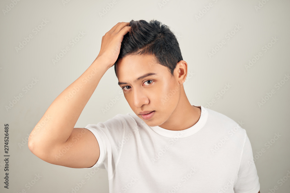 Fashion portrait of a handsome man. Man runs a hand through his hair Fashion portrait of a handsome man. Man runs a hand through his hair