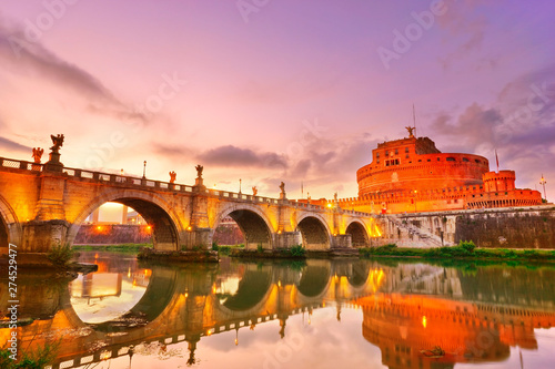 View of the Castel Sant'Angelo and Aelian Bridge in Rome at dusk.