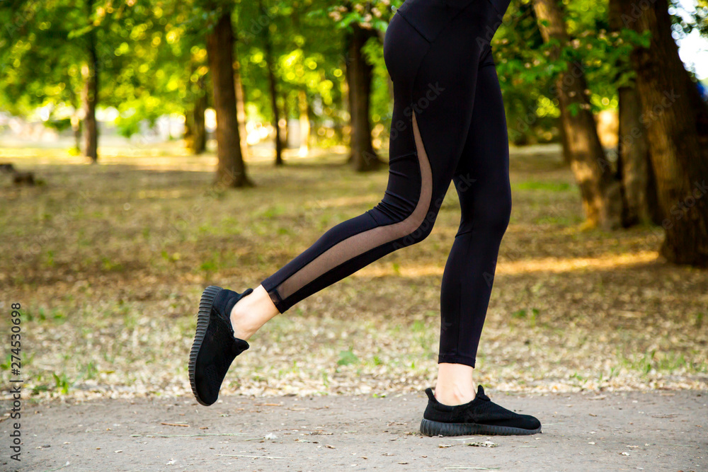 A young woman Jogging in the Park. Legs close up.