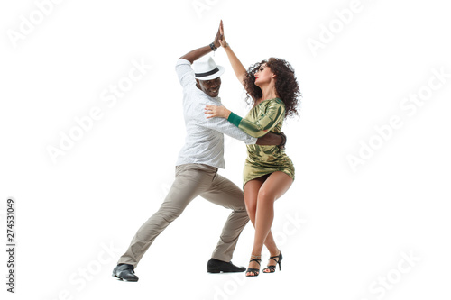 Elegant black man and gorgeous latin girl dancing samba isolated on white background.