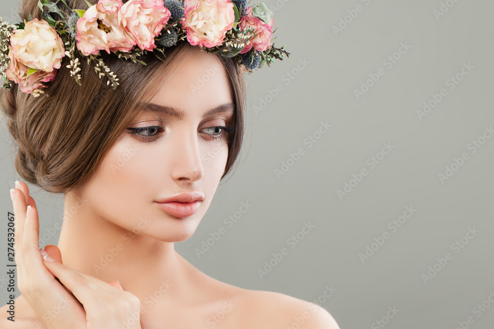 Naklejka premium Cute woman with flowers, summer spa portrait. Beautiful face