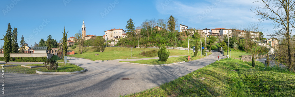Town skyline, northern Italy; Malnate with the bell tower of the church San Martino and to the left the cemetery connected with a staircase to the church of the town, province of Varese