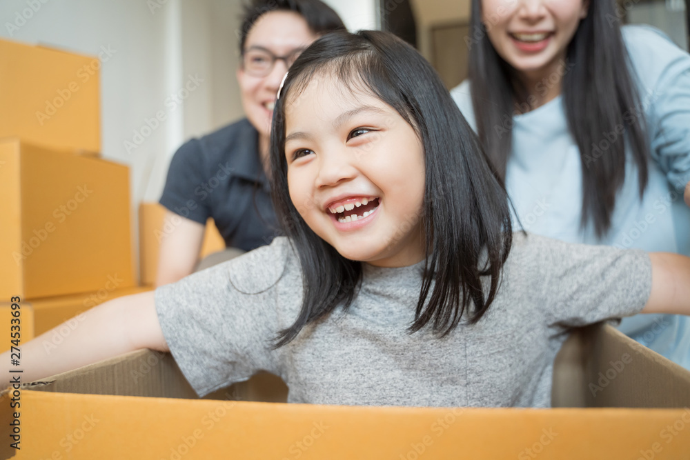 Portrait of happy Asian family moving to new house with cardboard boxes ...