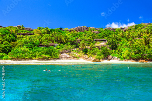 Fototapeta Naklejka Na Ścianę i Meble -  Felicite island at Seychelles seascape in Indian Ocean. People snorkel at Ramos National Park. Granite bloulder stones and turquoise bay. Snorkeling paradise in Marine Park. Tropical nature background