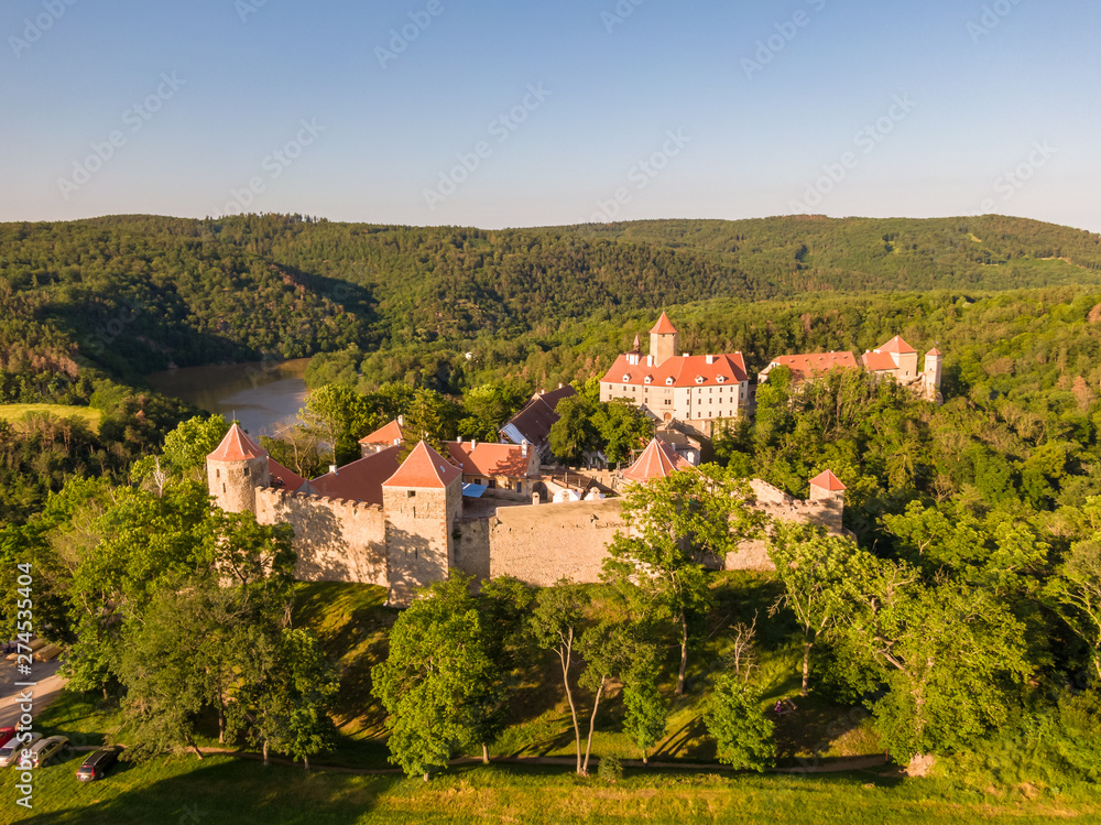 Aerial photo of Veveri castle near Brno city. South Moravia region, surrounded by river Svratka. Summer day with blue sky, sunset and soft light.