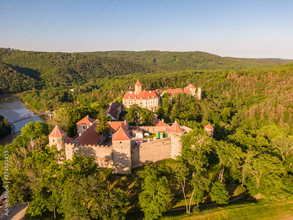 Obraz premium Aerial photo of Veveri castle near Brno city. South Moravia region, surrounded by river Svratka. Summer day with blue sky, sunset and soft light.