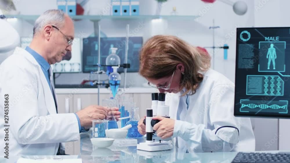 Busy and productive team in modern high end laboratory Busy and productive team in modern high end laboratory