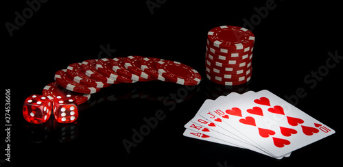 on a black background, red chips and dice, near the alignment in poker, street