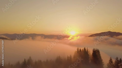 Surreal sunrise in the Smoky mountain skies. Drone video lifting up and panning to reveal the sunrise through the clouds in the Blue Ridge Great Smoky Mountains of Tennessee