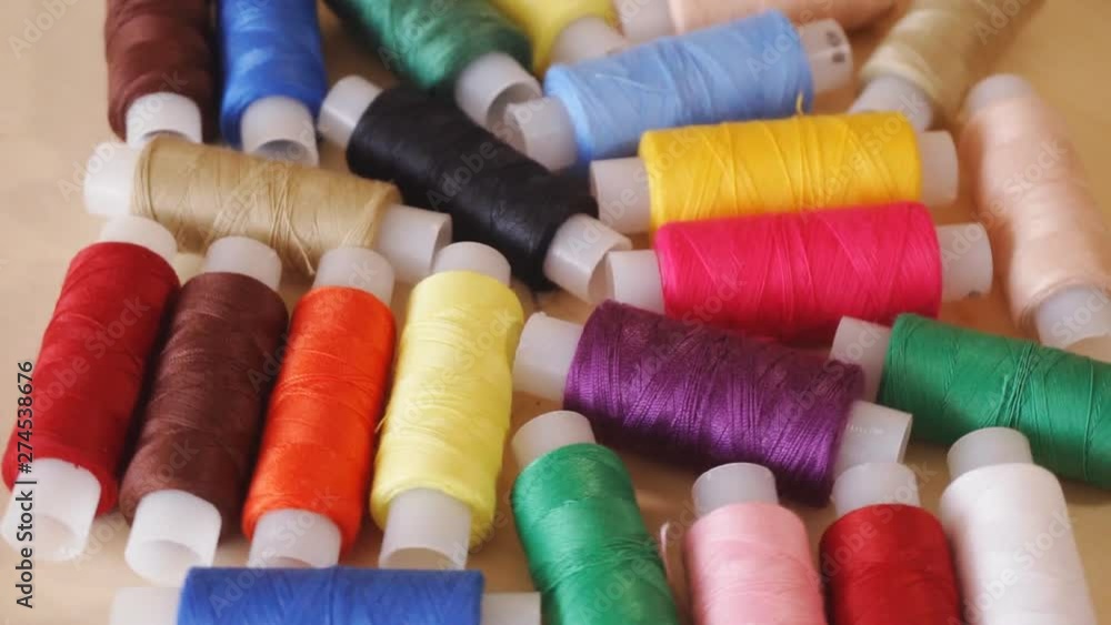 Sewing threads. Colorful thread spools used in fabric and textile industry. Rotation Sewing threads. Colorful thread spools used in fabric and textile industry. Rotation