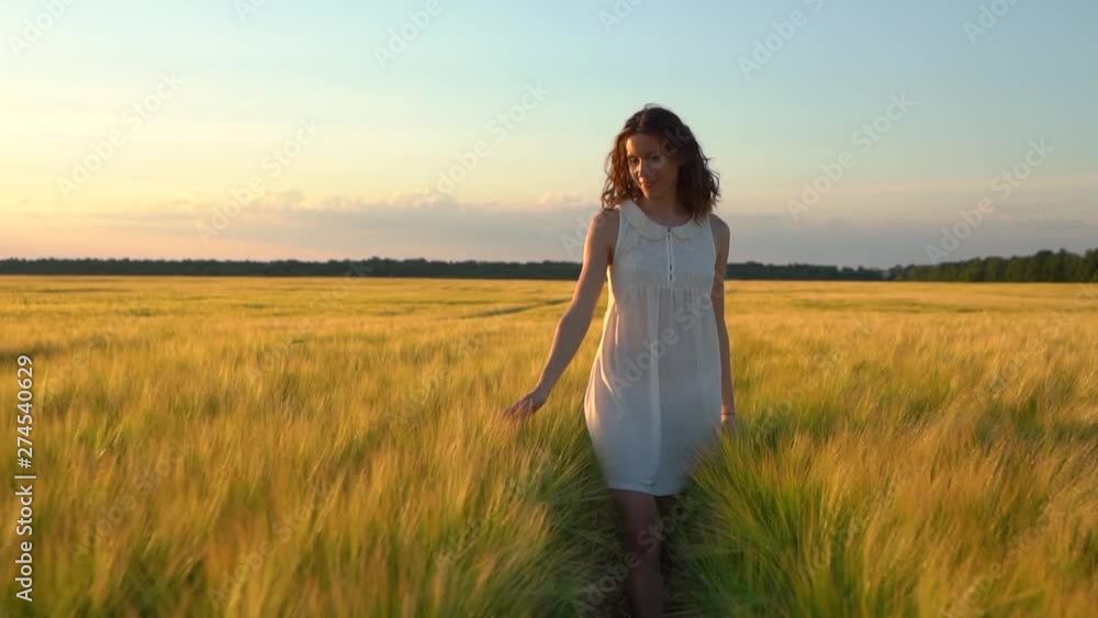 Woman touching wheat ear in wheat field Woman touching wheat ear in wheat field