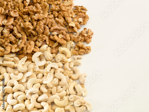 Walnuts and cashews on a completely white background.